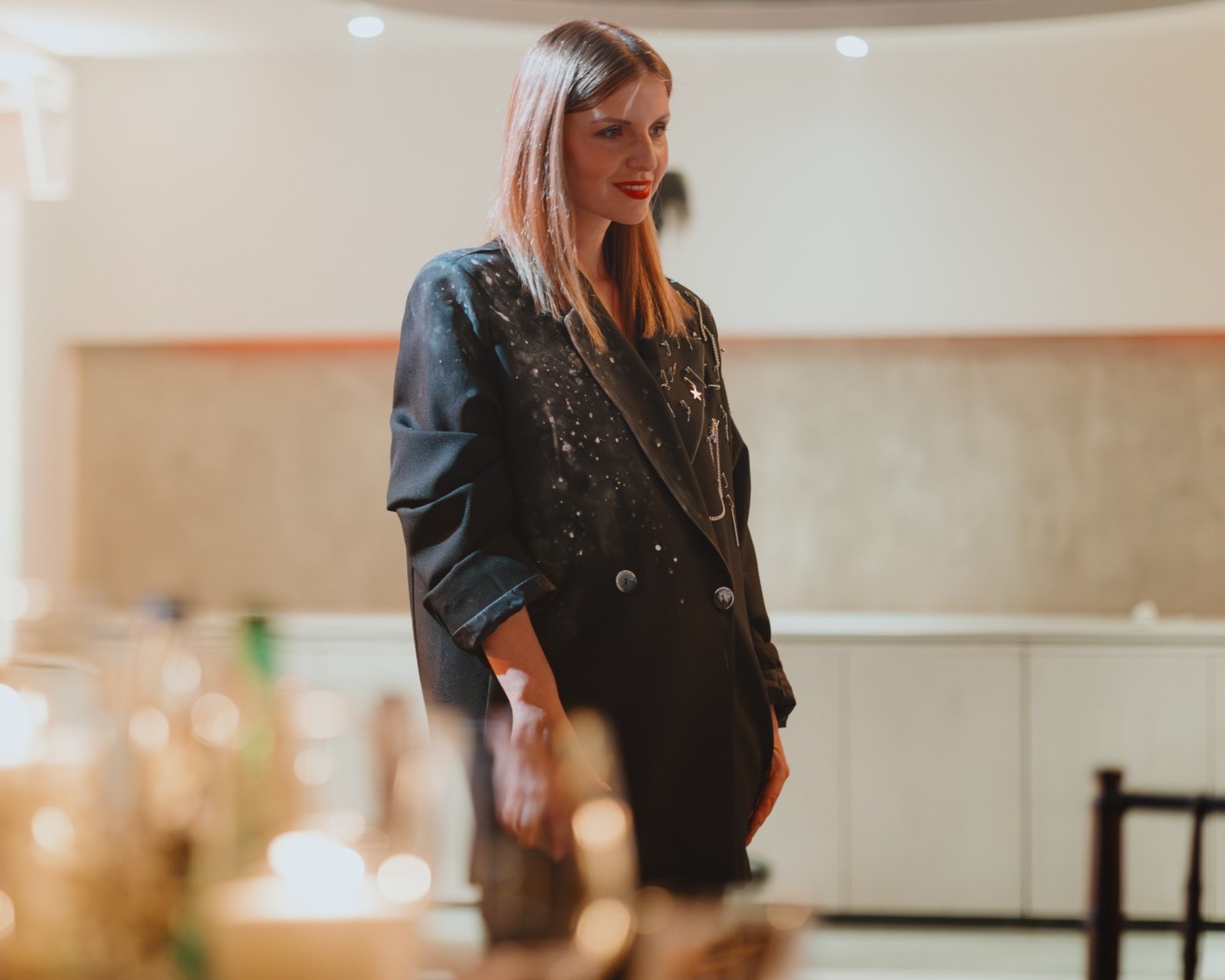 Masha Welt, DMC and event producer in Belgrade, at an evening event, candles on the table in the foreground